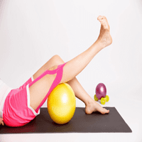 A woman is doing exercises on the floor